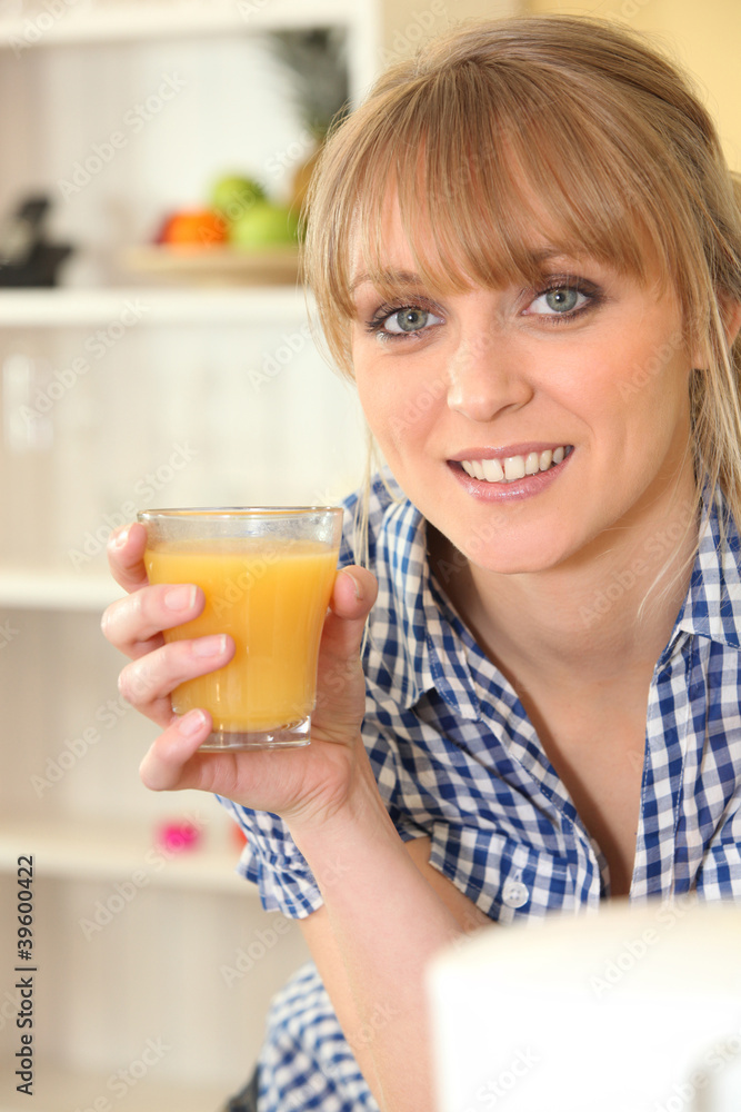 Woman drinking a glass of orange juice Woman drinking a glass of orange juice