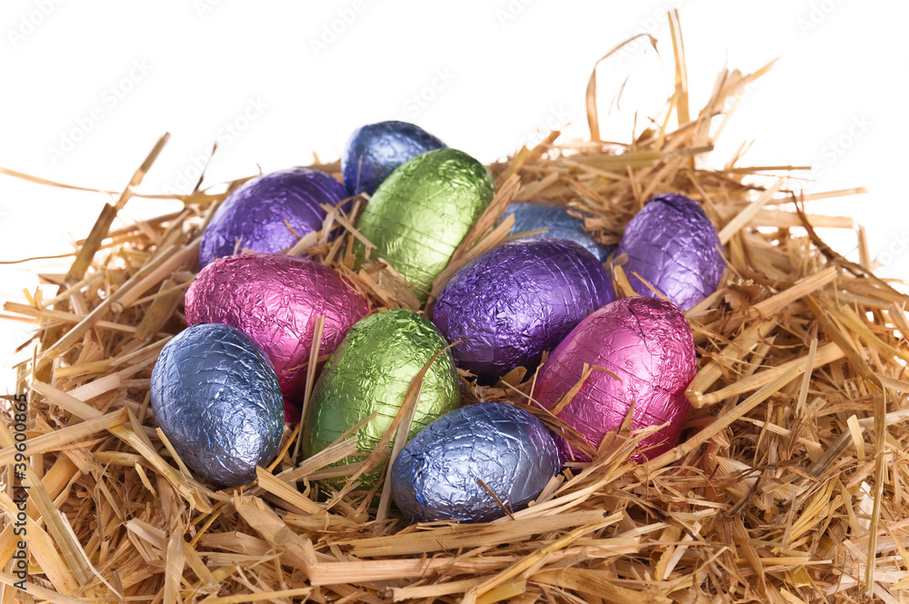 Straw nest with chocolate Easter eggs Straw nest with chocolate Easter eggs