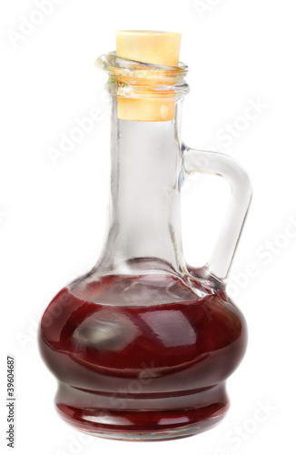 Small decanter with red wine vinegar isolated on the white backg