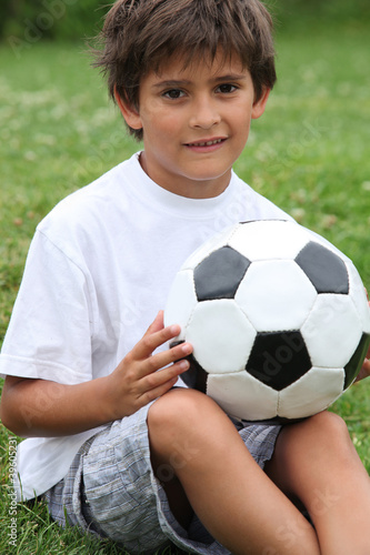 Little boy holding football © auremar