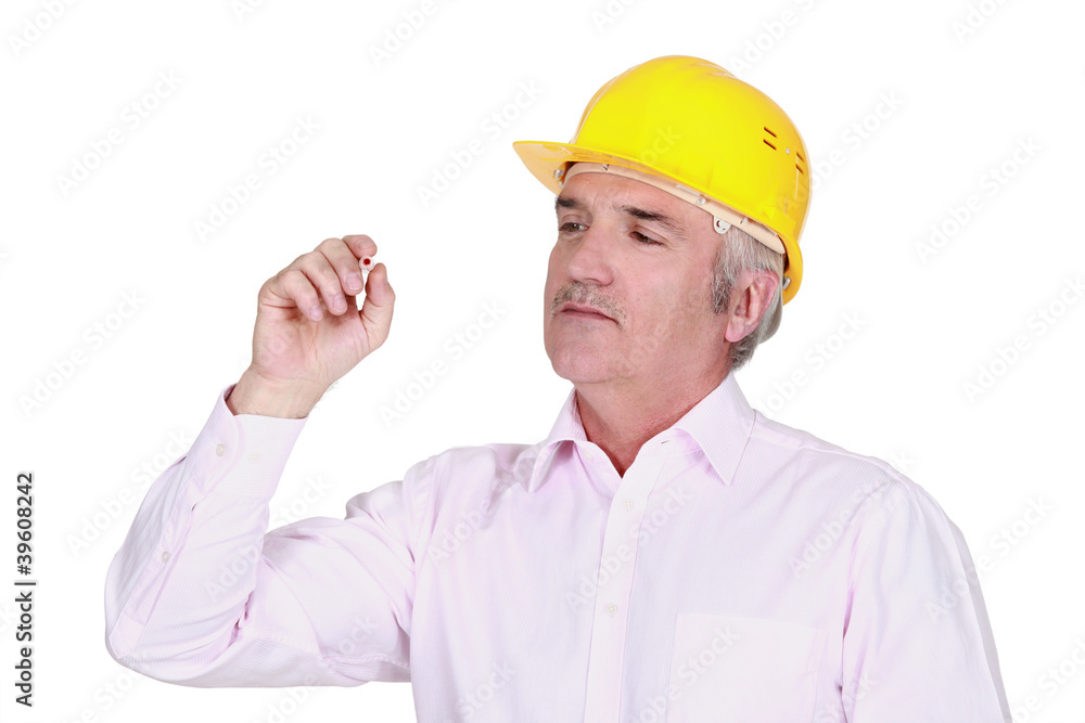 senior businessman wearing a helmet and looking at something senior businessman wearing a helmet and looking at something