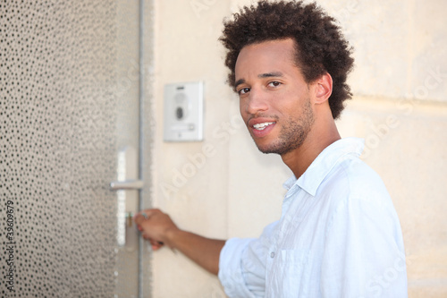 Man putting key in door