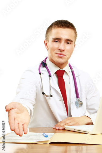 A male doctor suitting on the desk and stretching his arms