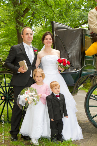 newlyweds in front of hores carriage photo