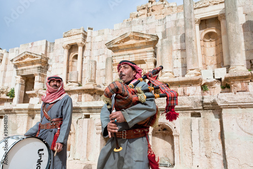 bedouin plays on bagpipes in ancient town Gerasa in Jordan photo