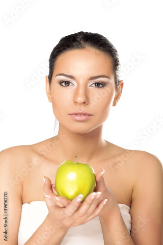 A portrait of beautiful young woman with a green apple