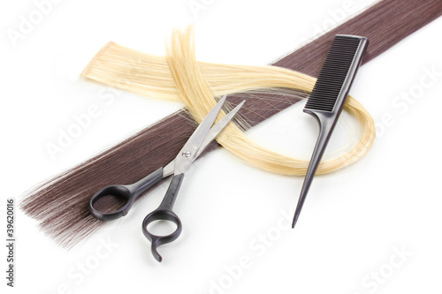 Shiny blond and brown hair with hair cutting shears and comb