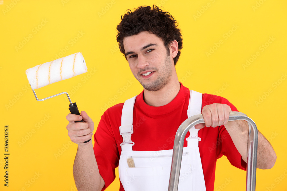 Decorator with a paint roller Decorator with a paint roller