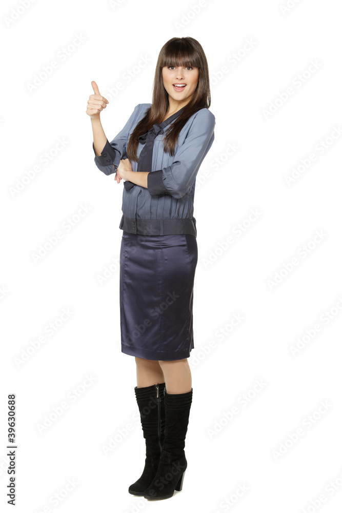 Full length of young surprised female showing thumb up Full length of young surprised female showing thumb up
