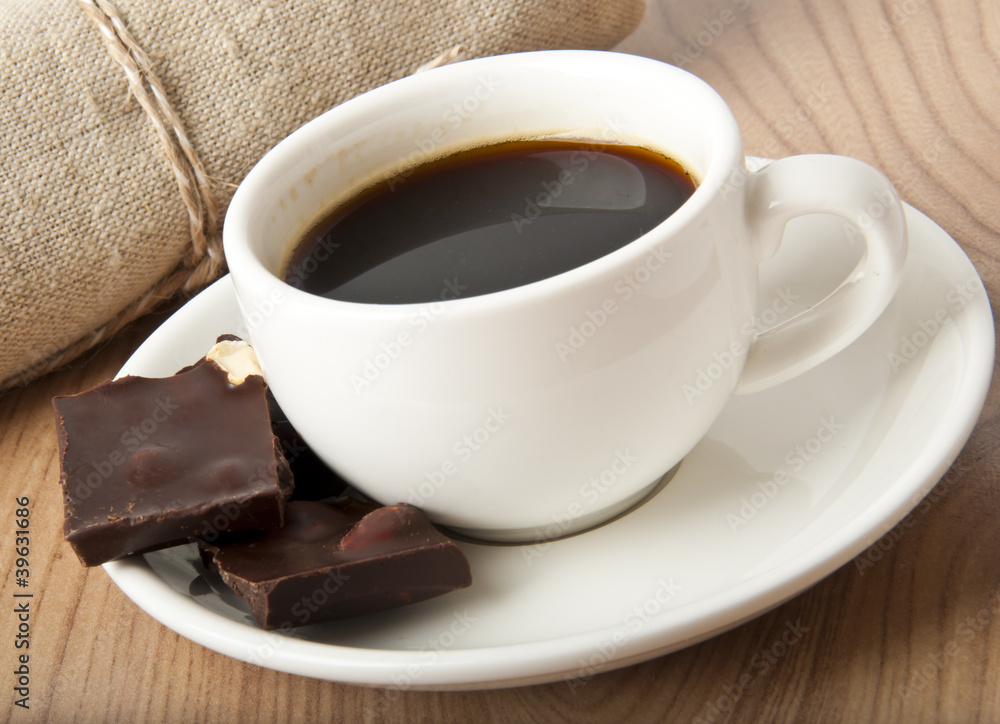 cup of coffee and chocolate on a dark background cup of coffee and chocolate on a dark background