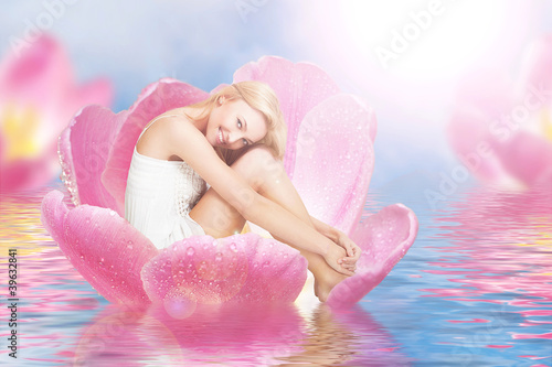 Fotografie Young woman as Thumbelina on tulip