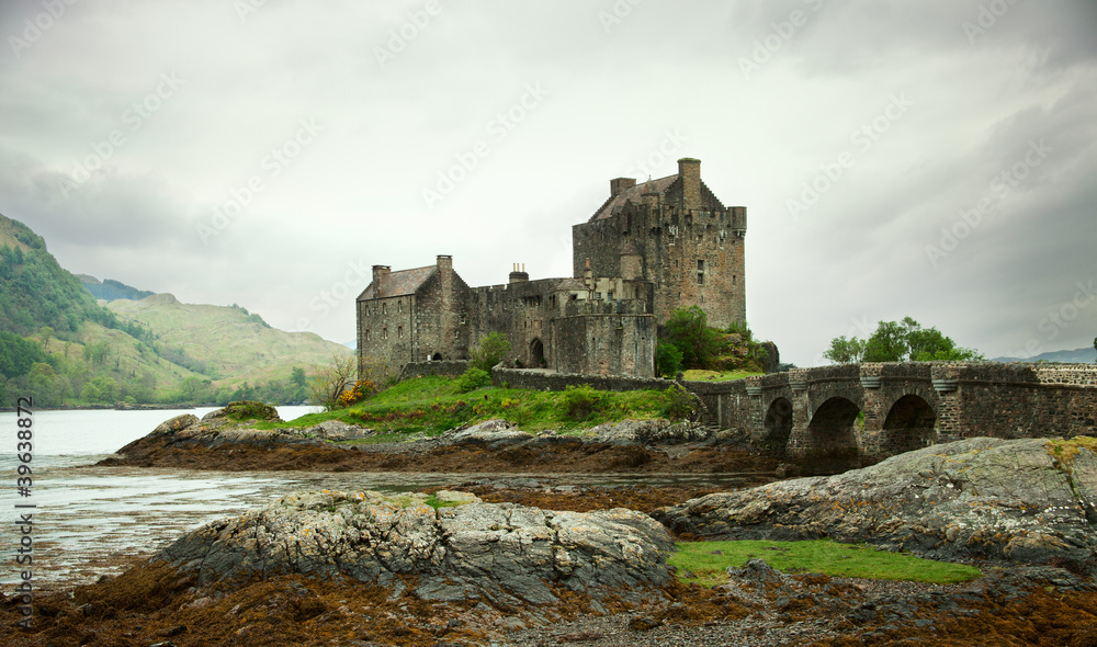 Eilean Donan castle on a cloudy day. low tide. Scotland