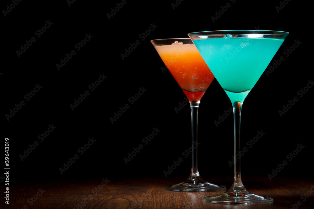 Red and blue cocktails on a black background