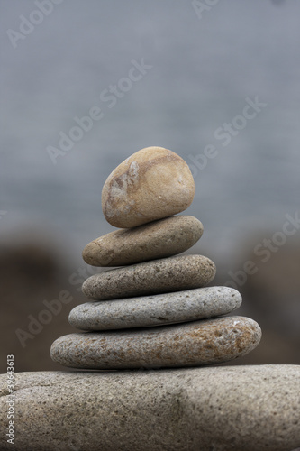 Canvas Print many round stones on tower