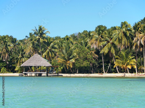 Tropical beach with thatch hut overwater, Caribbean sea, Central America, Panama