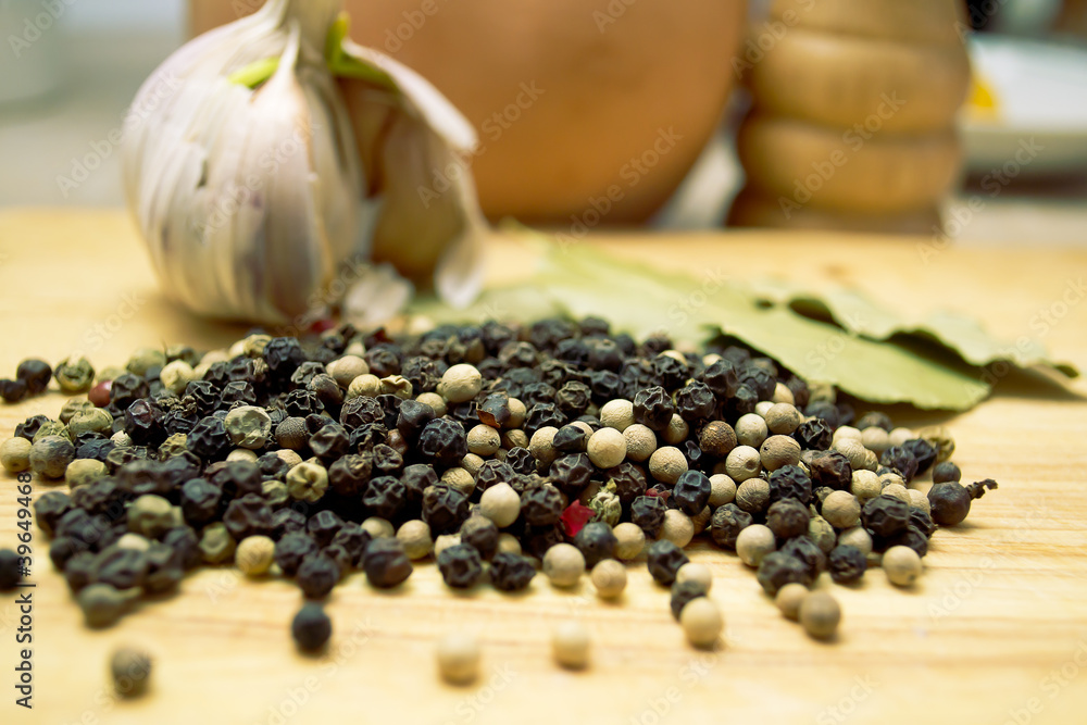 pepper and garlic on a wooden table pepper and garlic on a wooden table