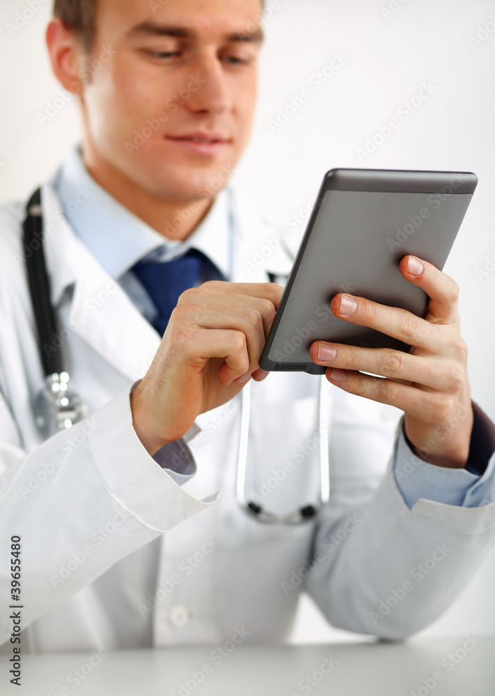 Handsome doctor using computer plane-table Handsome doctor using computer plane-table
