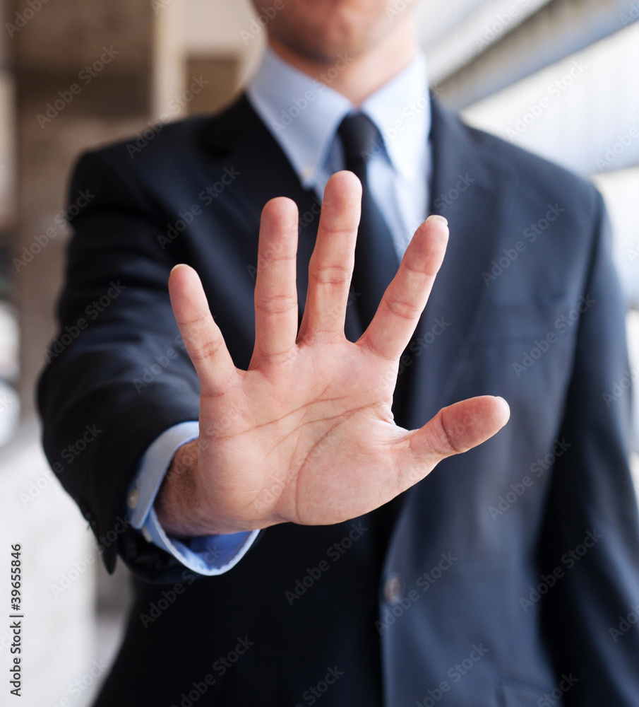 Business man holding out hand, indicating stop Business man holding out hand, indicating stop