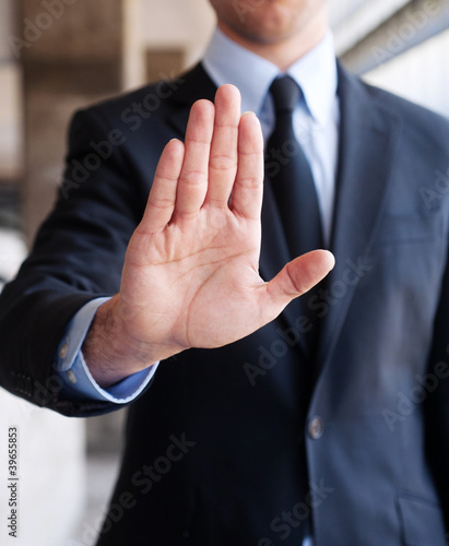 Business man holding out hand, indicating stop