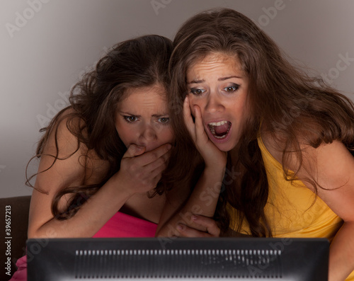 Gemini sisters watching a horror movie on TV photo