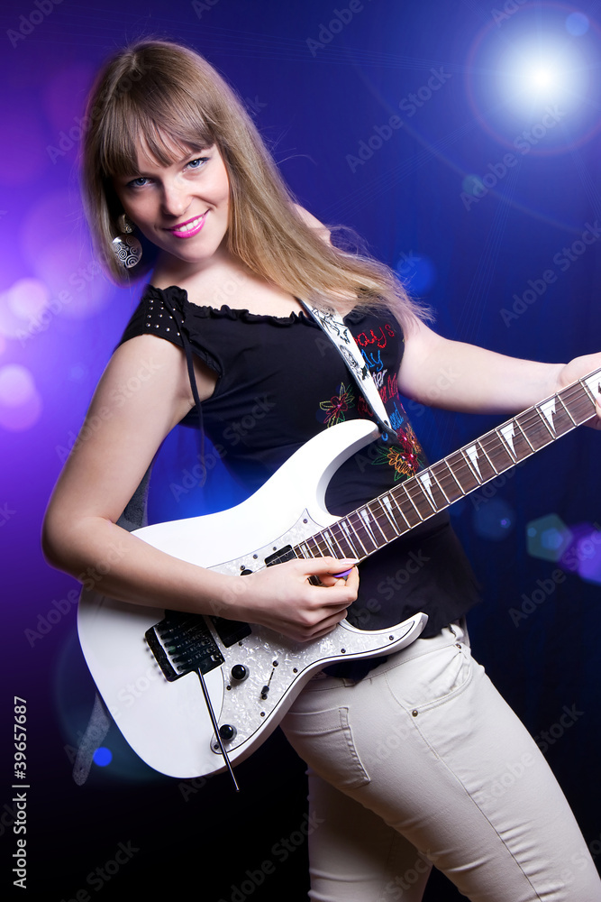 Obraz premium fashion girl with guitar playing hard rock