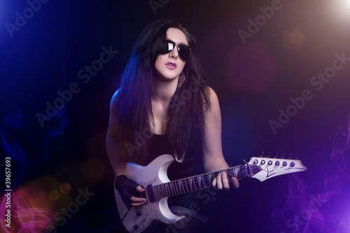 fashion girl with guitar playing hard rock