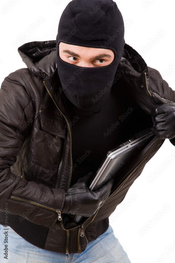 Thief holding a laptop, isolated over white background