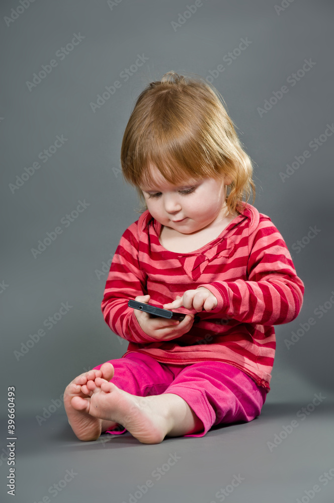 Cute little girl with mobile phone Cute little girl with mobile phone
