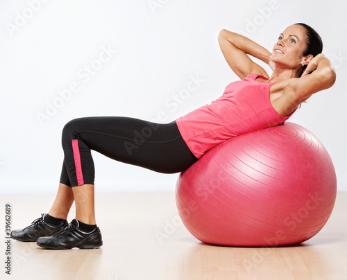 Beautiful athlete woman with a fitness ball.