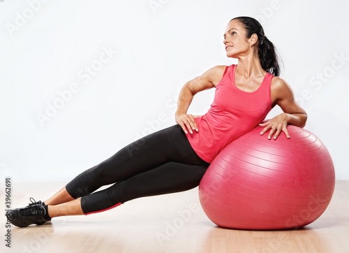 Beautiful athlete woman with a fitness ball.