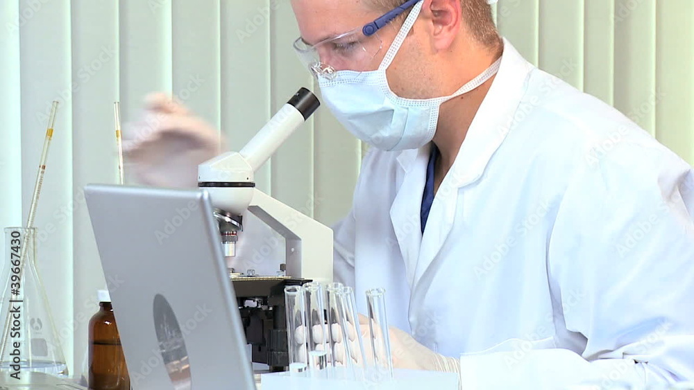 Male Medical Student with Microscope and Laptop Male Medical Student with Microscope and Laptop