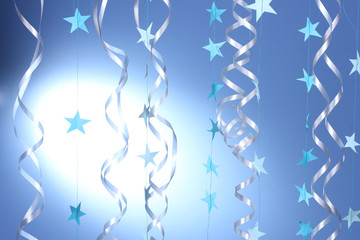 beautiful streamers and stars on blue background