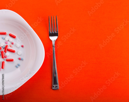 Pills on plate with fork