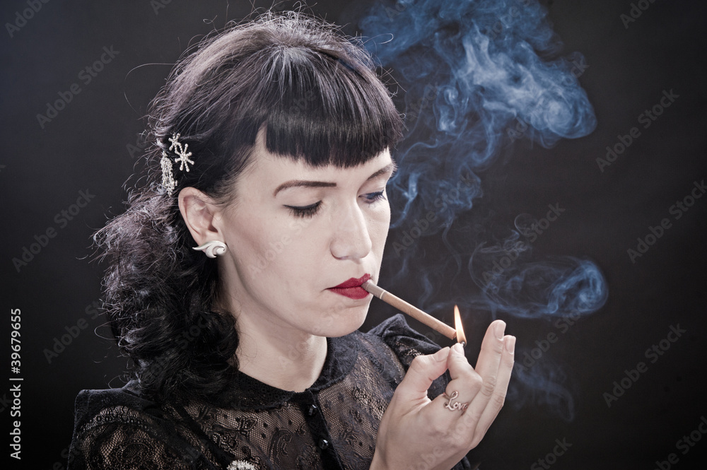 Fototapeta premium Retro women with cigarette on black background
