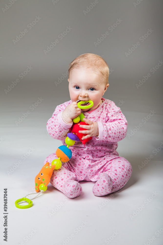 Infant girl playing in room on wooden floor Infant girl playing in room on wooden floor