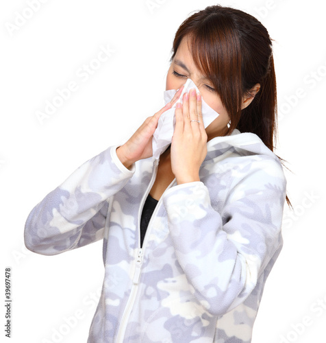 sick woman blowing nose