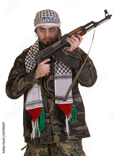Portrait of man standing with rifle against white background
