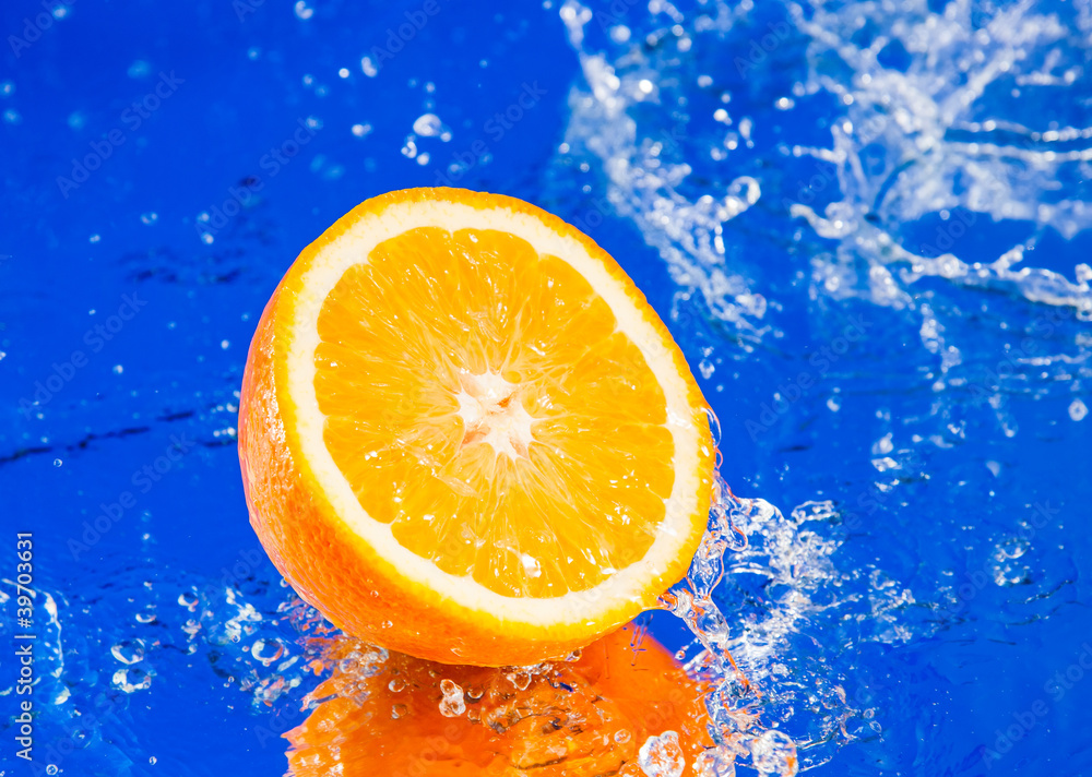 Half of orange in water splash Half of orange in water splash