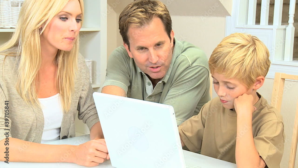 Caucasian Family With a Laptop Computer Caucasian Family With a Laptop Computer