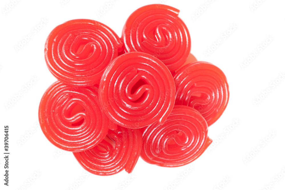 Pile of red licorice spirals on white background. Close up Pile of red licorice spirals on white background. Close up