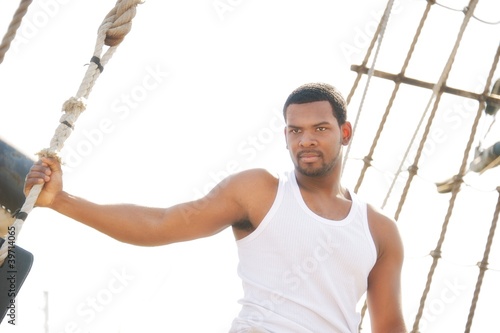 Handsome afro-american man on boat's deck.