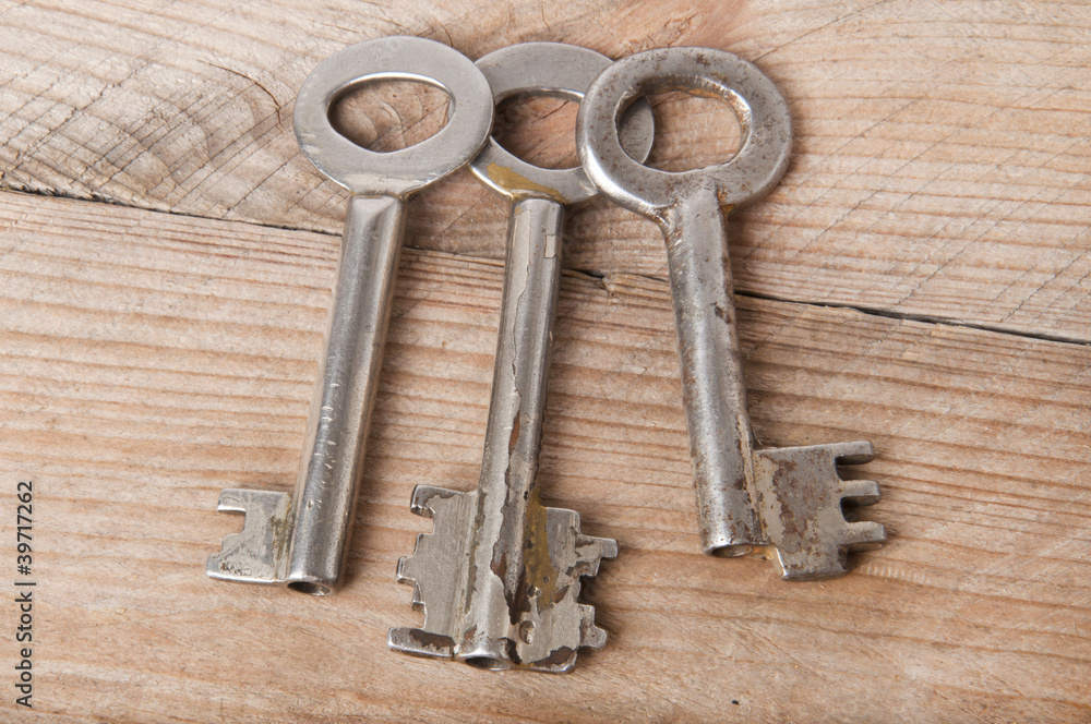 Old keys on a wooden background Old keys on a wooden background