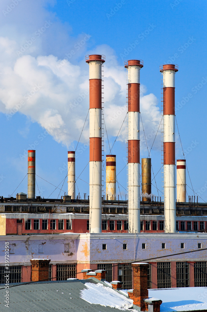 Obraz premium Lots of smoking chimneys other blue sky