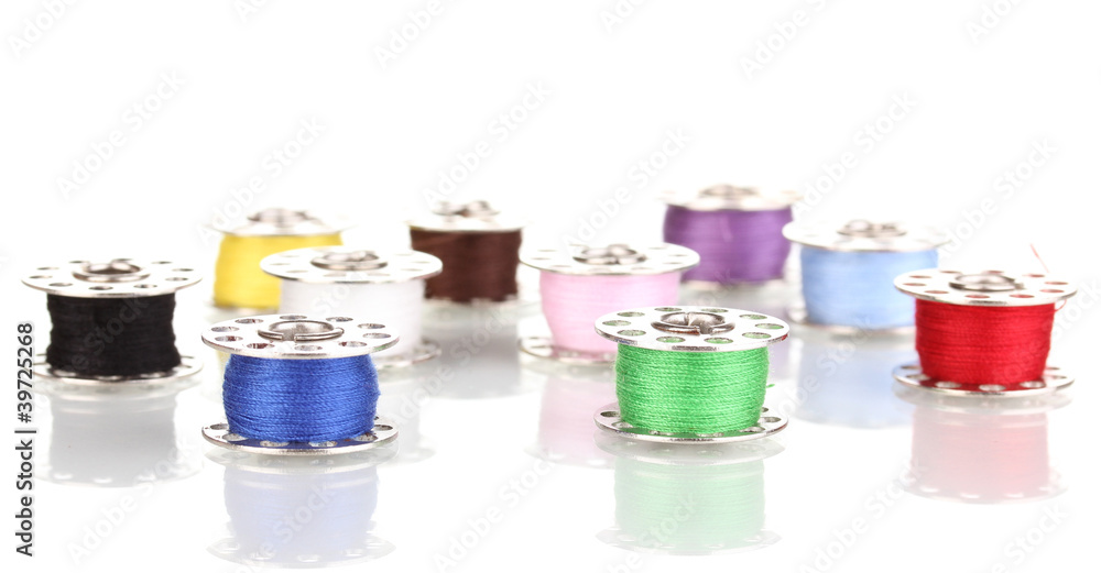 Metal spools of thread isolated on white