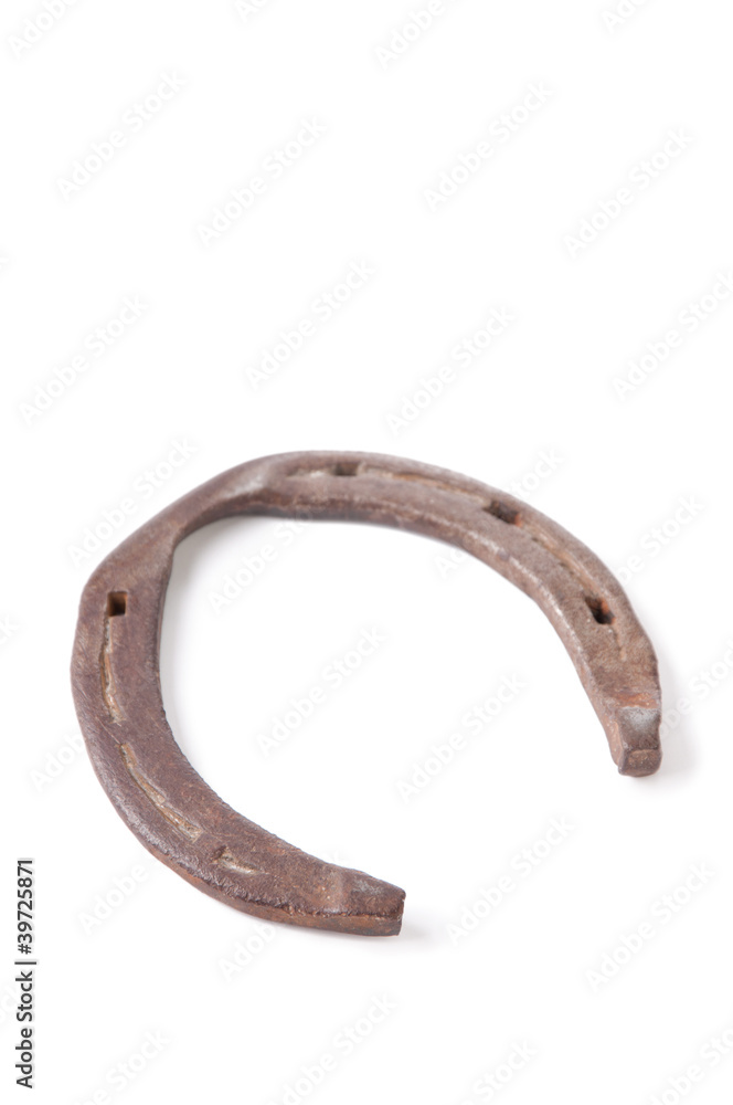 Studio shot of an old horseshoe isolated over white Studio shot of an old horseshoe isolated over white