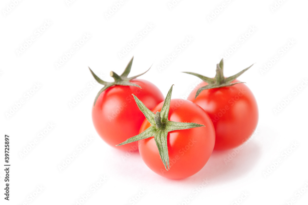 Small red cherry tomatoes, isolated over white Small red cherry tomatoes, isolated over white