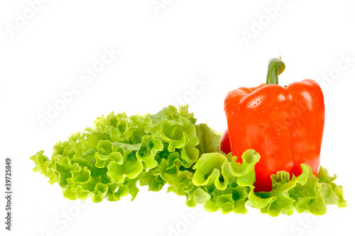 Pepper and salad leaf on dish isolated on white background