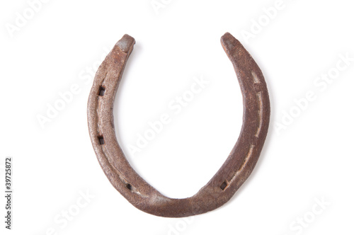 Close-up of an old, rusty horseshoe, white background