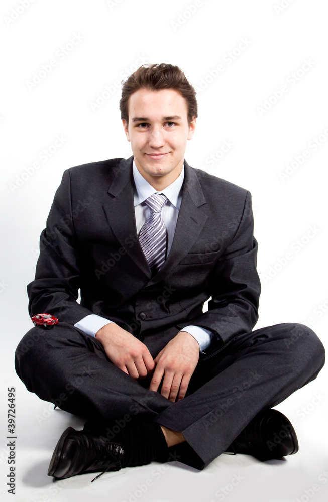 portrait of a young manager for motor with a small red toy car portrait of a young manager for motor with a small red toy car
