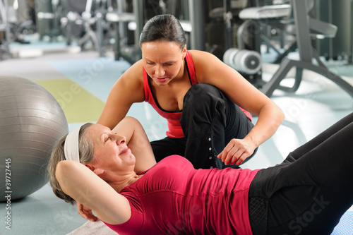 Senior woman exercise abdominal in fitness center